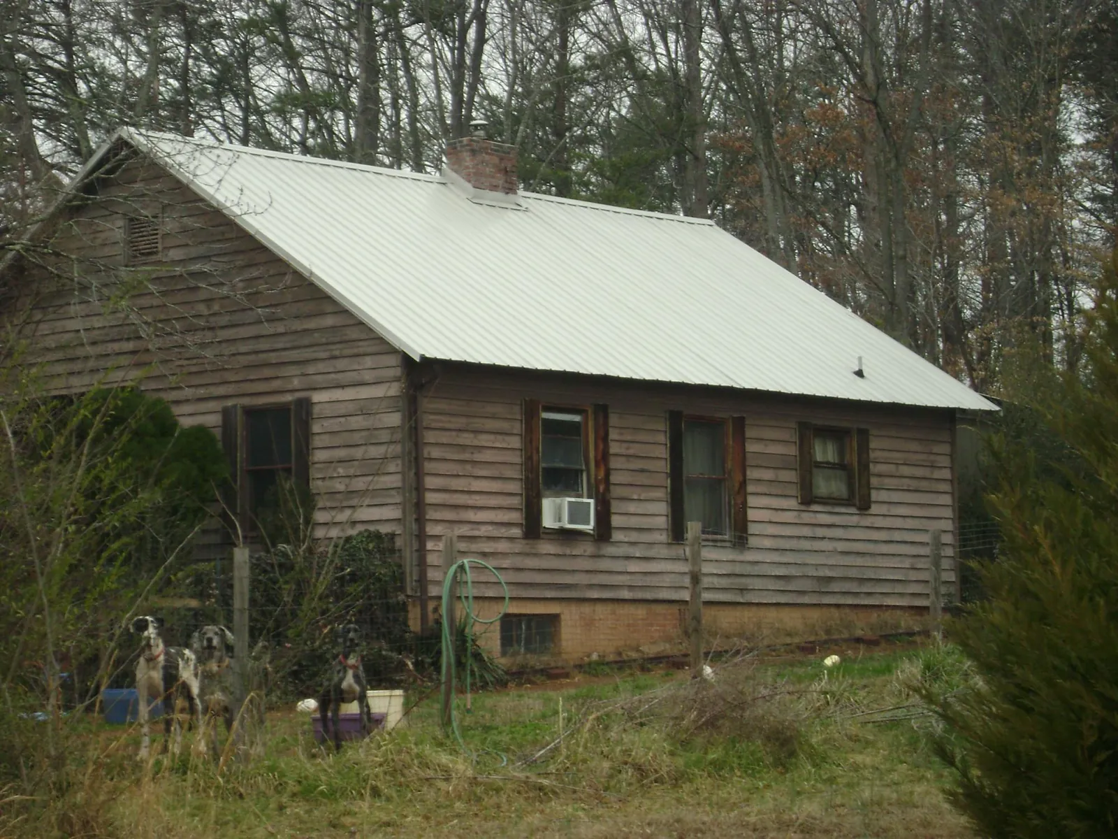 White metal roof on an old wood sided farmhouse, from a Metal Roof Installation job in Le Roy